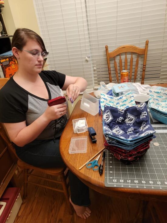 Woman putting finishings touches on bowl cozies